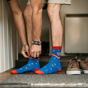 Person wearing Super Dad Crew Socks in blue, red and yellow cotton